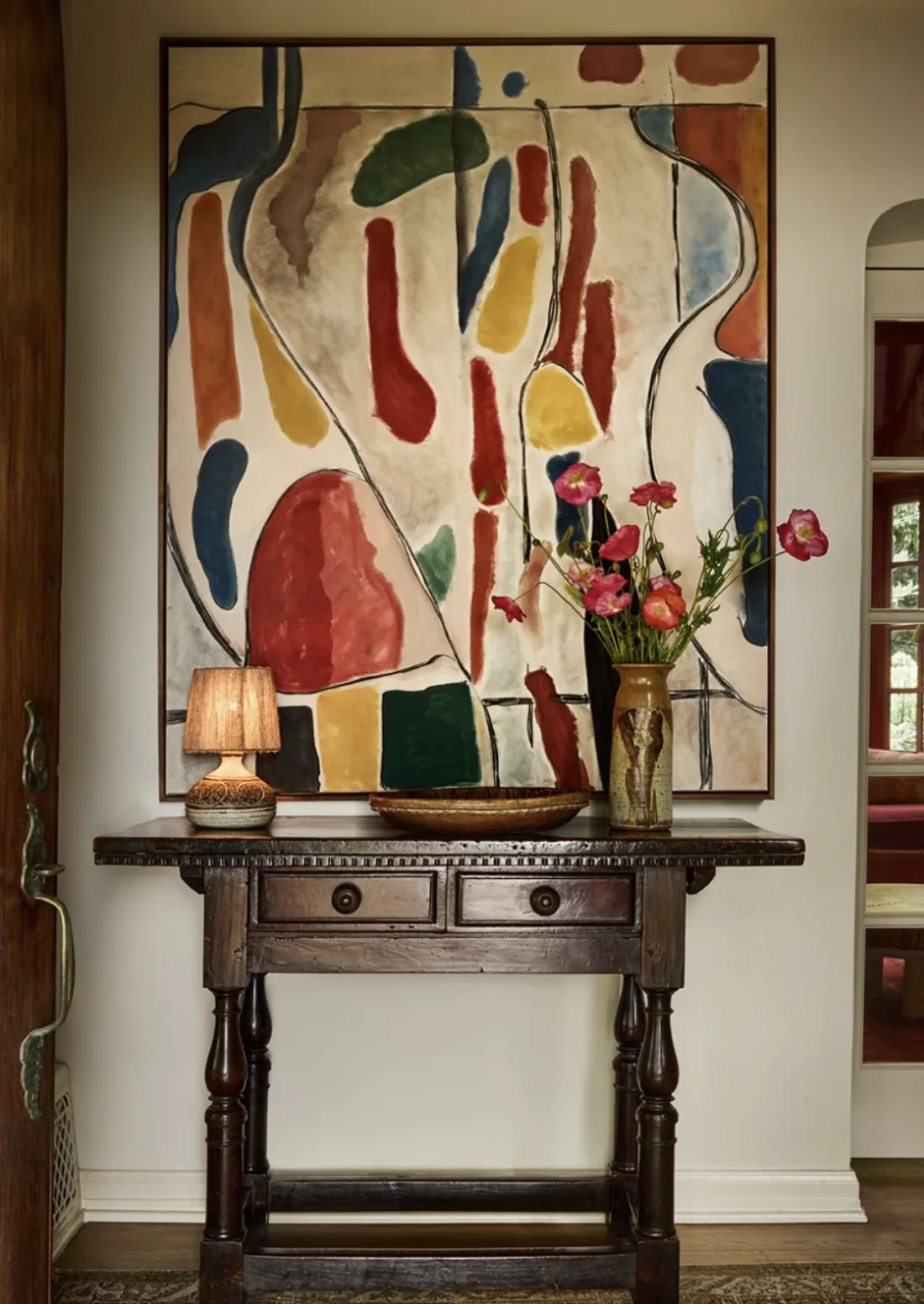 Alexander Design Build — console with abstract canvas and poppies