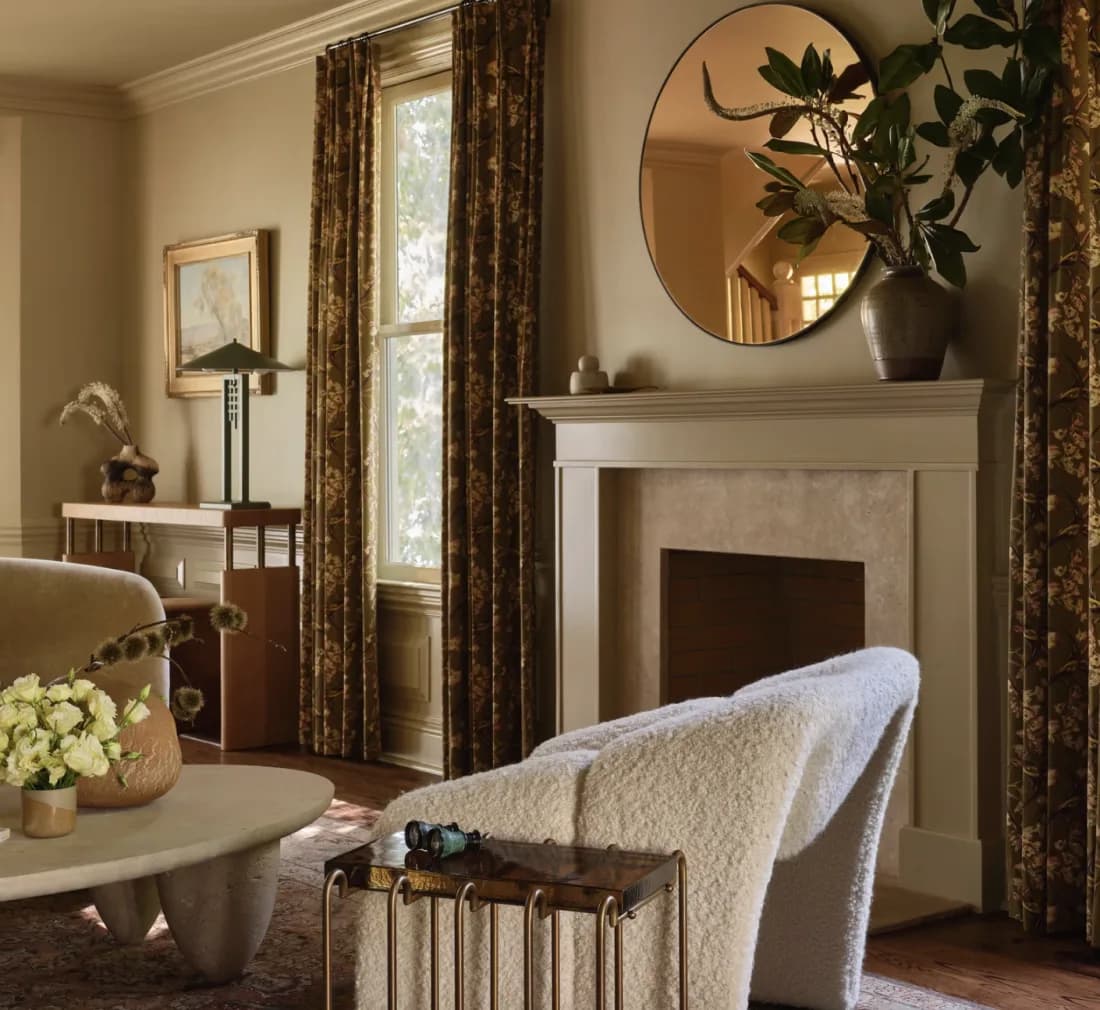 House of Honey — sitting room with round mirror and fireplace